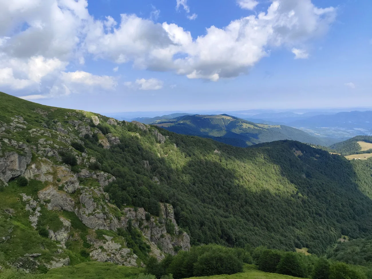 Green slopes and rocky ridges of the Rhodope mountains in summer