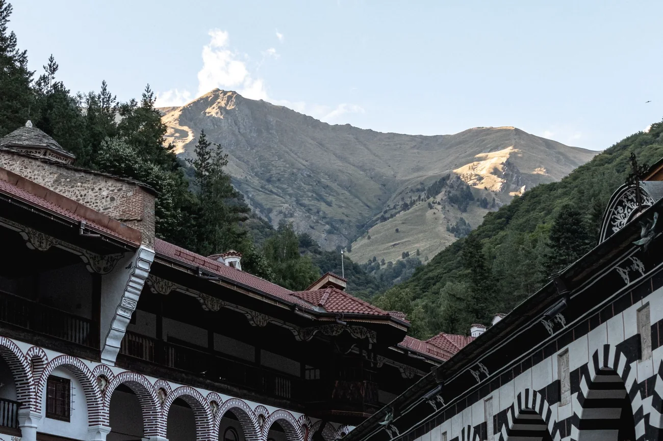 Arcaded courtyard of Rila Monastery with the Rila mountains rising behind it