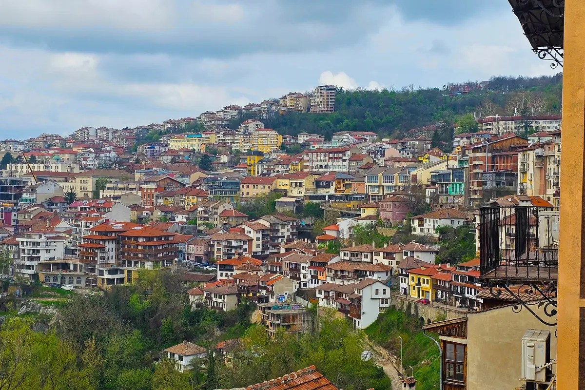 Colourful houses and red roofs climbing the green hillside of Veliko Tarnovo